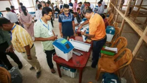 Visuals related to recent electoral reforms, such as images of voter ID cards, people casting votes, and the NOTA option on ballot papers.